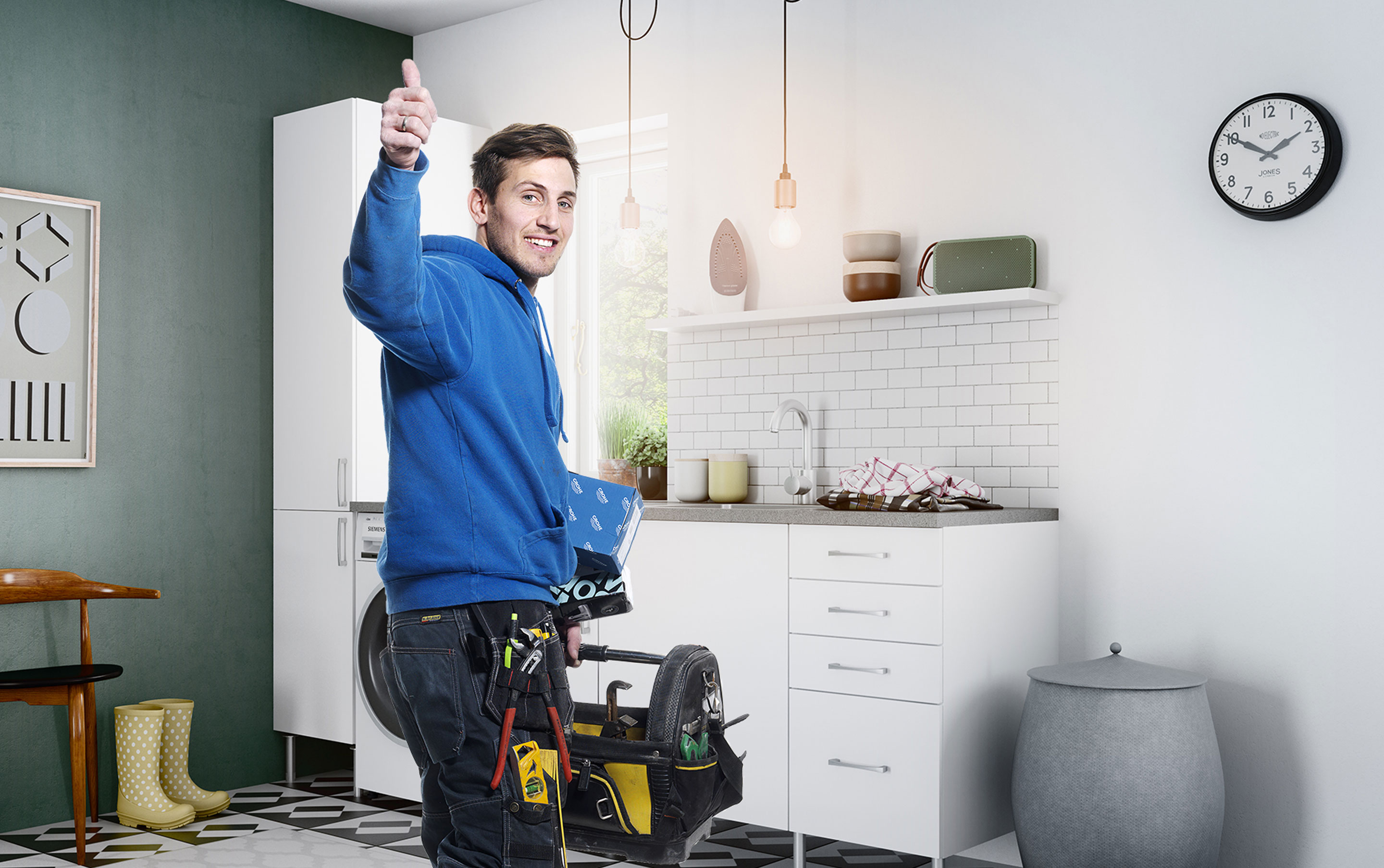 Mann med blå genser som gir tommel opp til kameraet